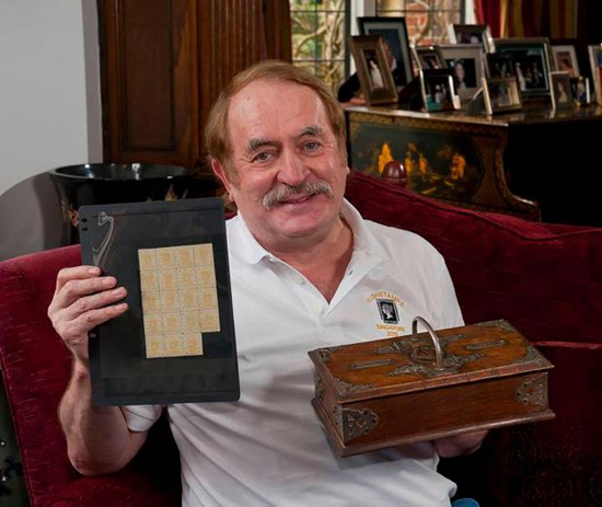 Stamp dealer Allan Grant with stamps and cigar box Photo © Chris Balcombe